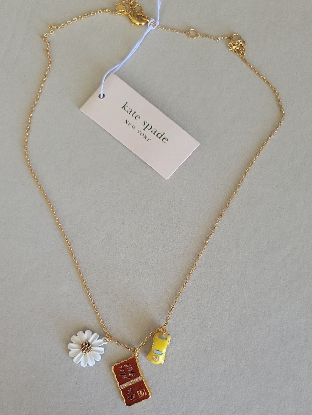 Kate Spade Gold Chain Necklace with Daisy, Yellow Car & 'Girls Trip' Charm - Picture 2 of 8